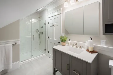 a bathroom with a sink double vanity mirror and shower