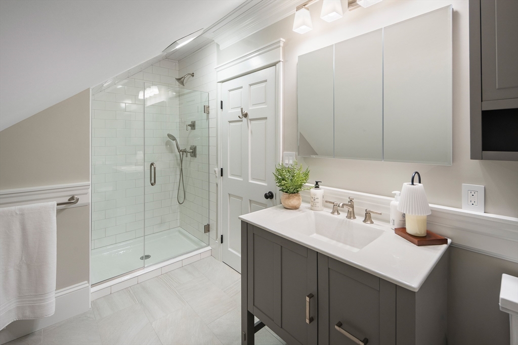48-50 Amsden Street, Unit 2 Arlington, MA 02474 - Photo 21 of 34 a bathroom with a sink double vanity mirror and shower