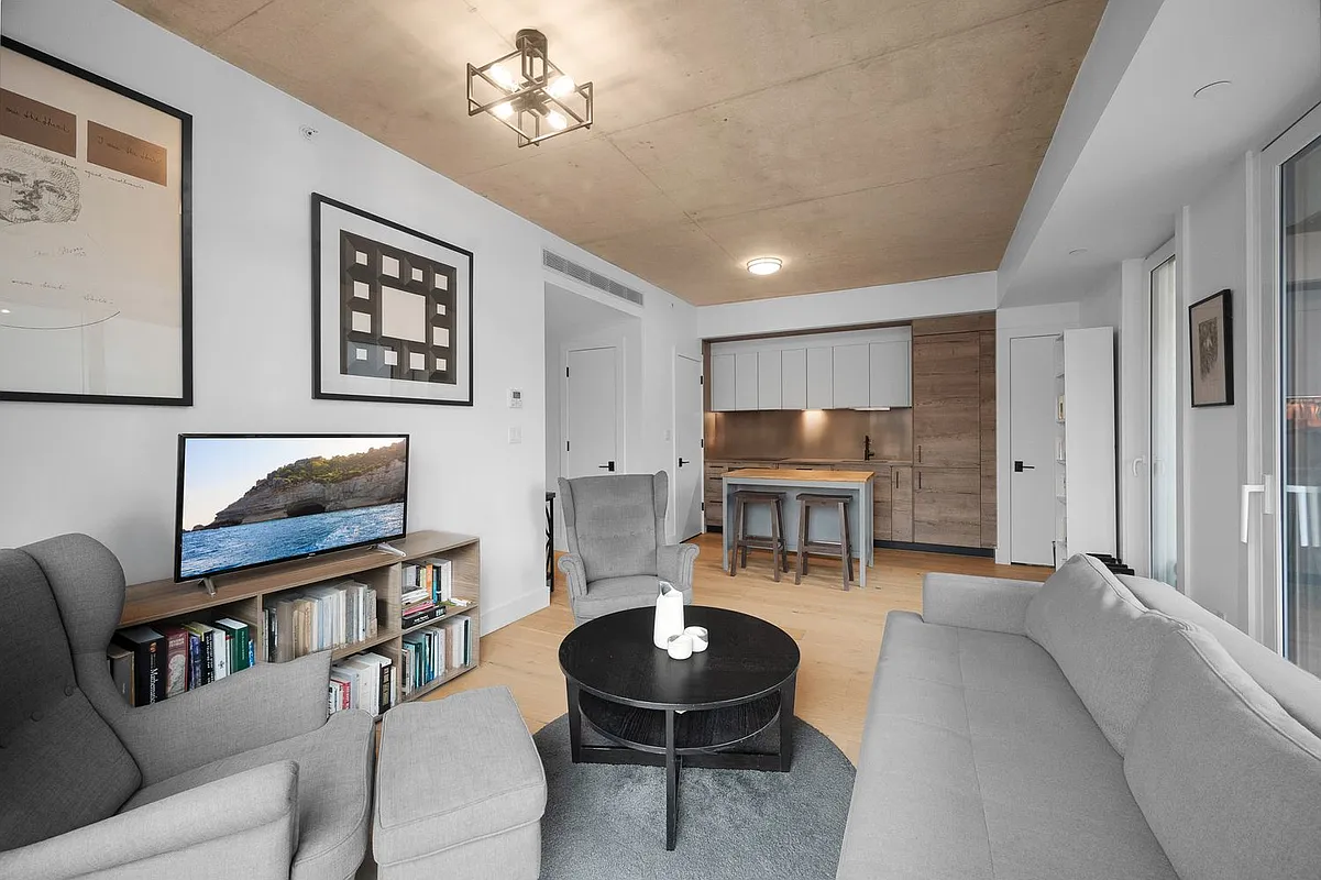 169 Huron Street, Unit 4A Brooklyn, NY 11222 - Photo 2 of 15 a living room with furniture and a chandelier