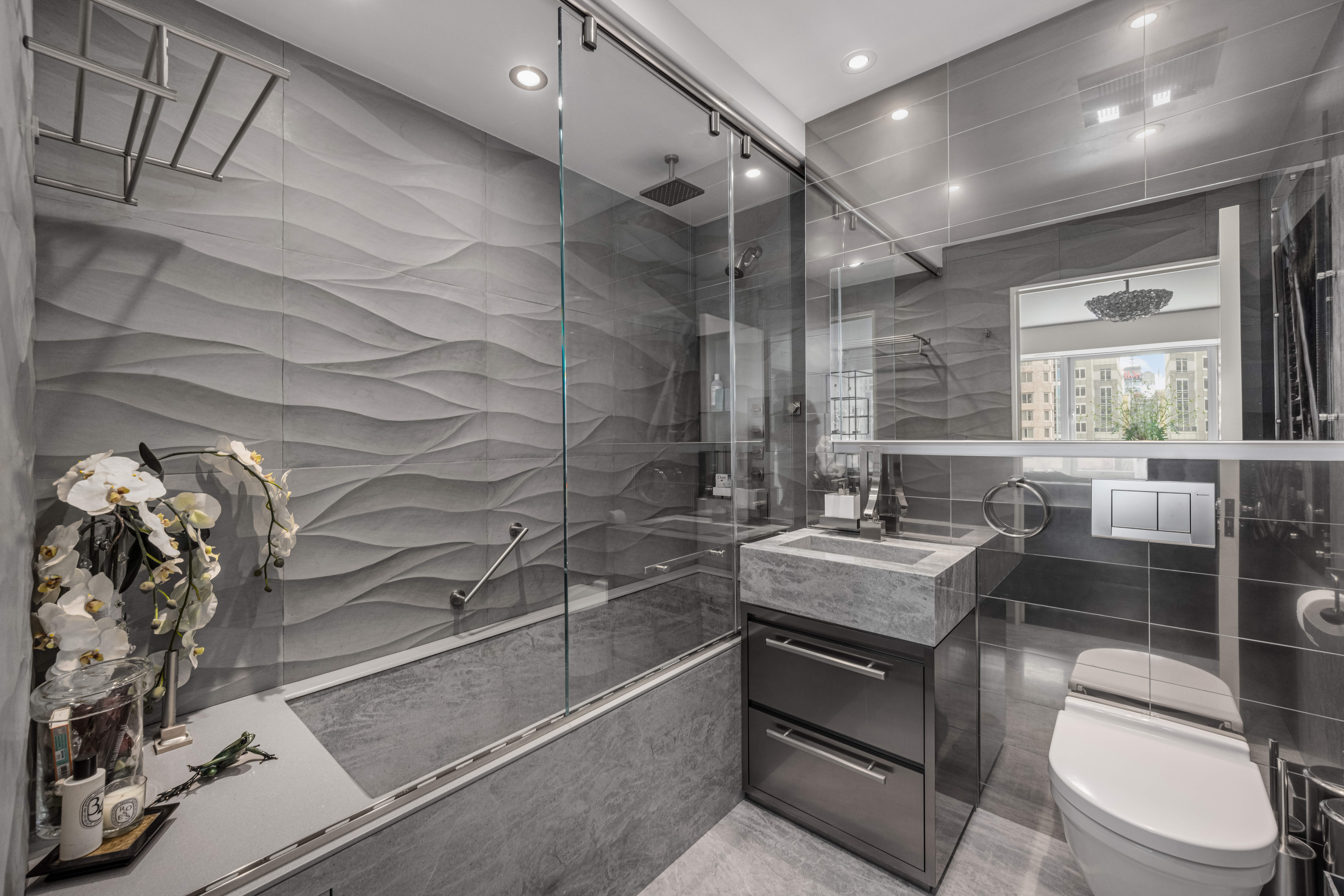150 West 56th Street, Unit 3901 Manhattan, NY 10019 - Photo 14 of 25 a bathroom with a sink a toilet and shower