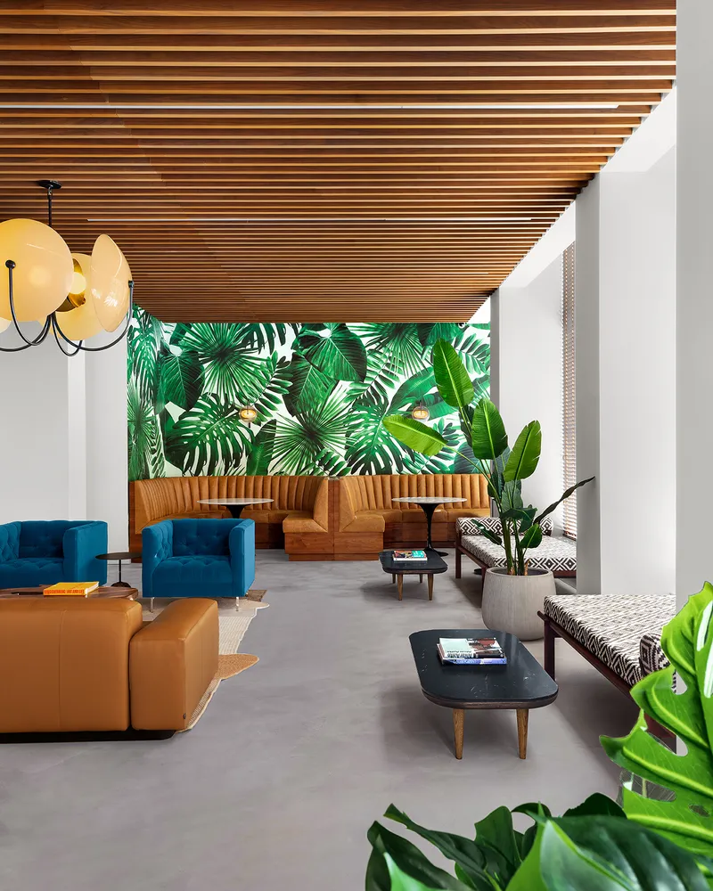 a living room with patio furniture and a potted plant