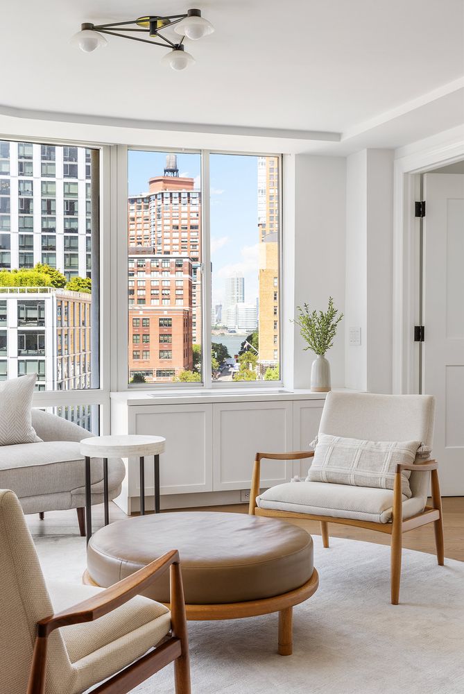 303 Greenwich Street, Unit 8DE Manhattan, NY 10013 - Photo 3 of 20 a living room with furniture and a large window