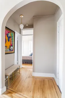 a view of a bedroom with wooden floor and a window