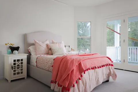 a bedroom with a bed and a window