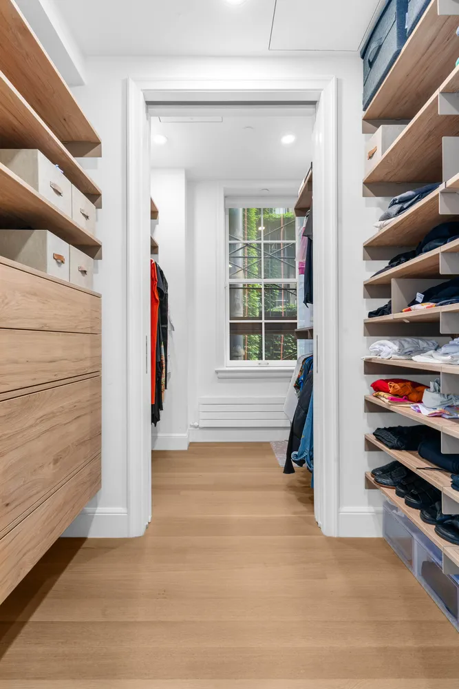 a view of an empty room with stairs and a window