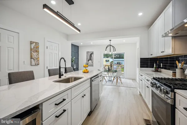 a kitchen with granite countertop a sink stainless steel appliances and cabinets