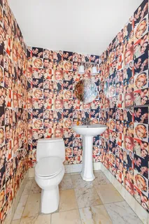 a bathroom with a toilet and a shower curtain