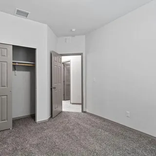 an empty room with closet area