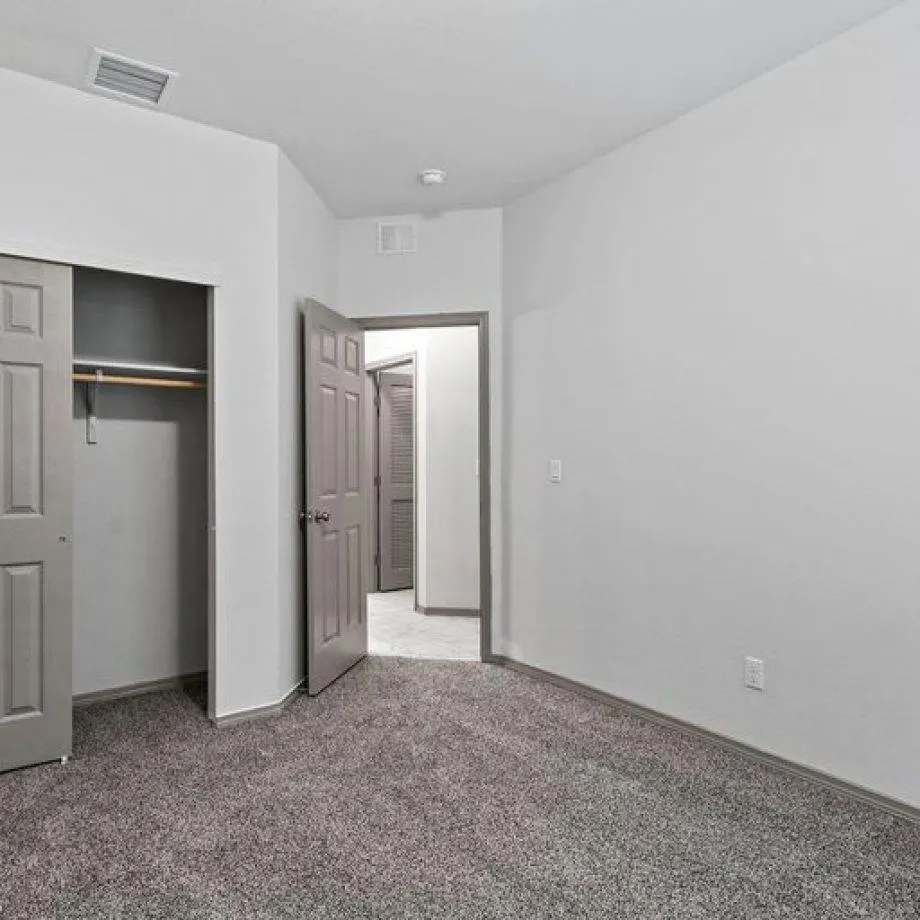 an empty room with closet area