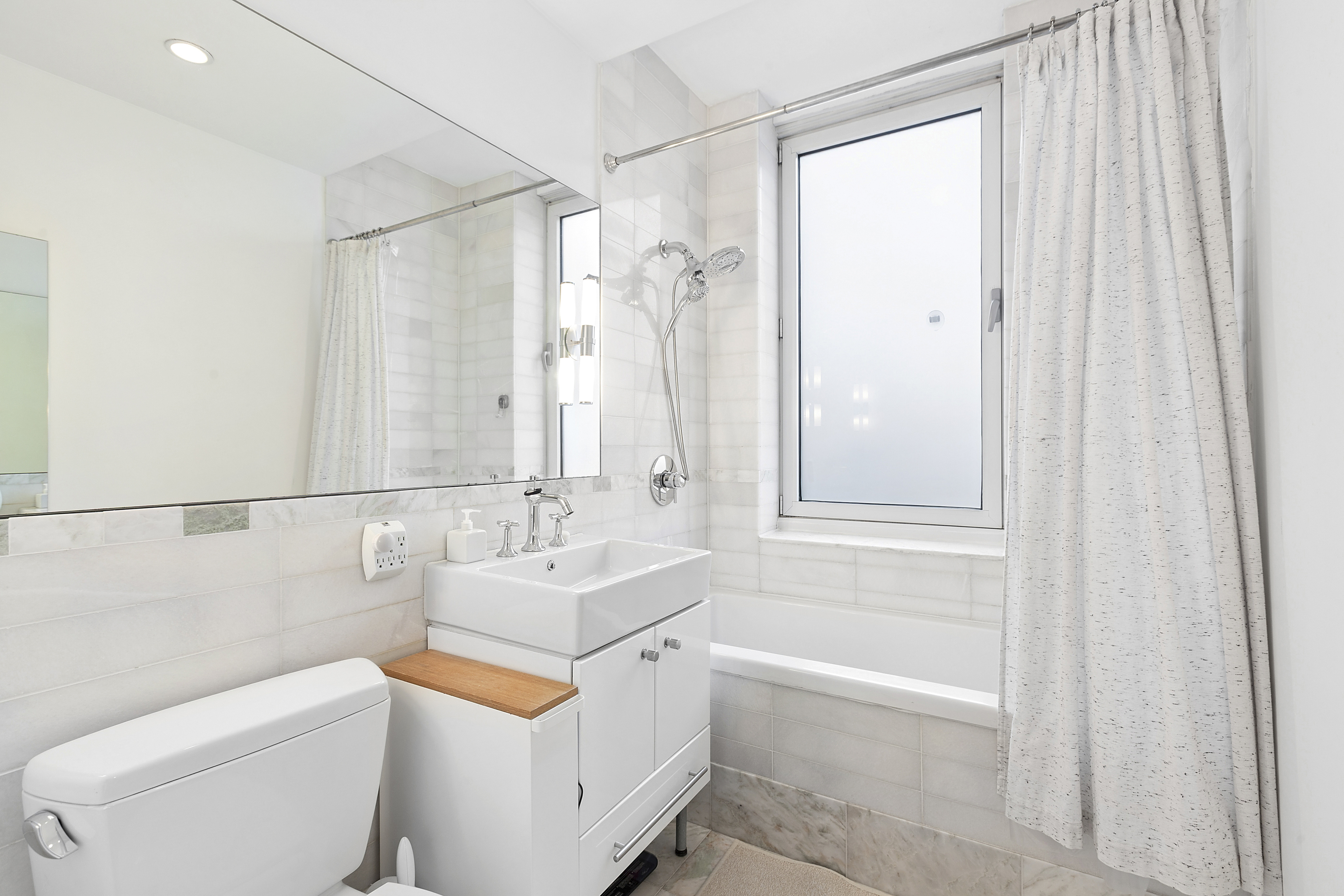 635 West 42nd Street, Unit 4B Manhattan, NY 10036 - Photo 4 of 11 a bathroom with a sink a toilet and shower