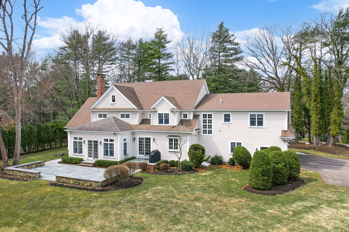Country Way Needham, MA 02492 - Photo 21 of 27 a front view of a house with a garden and trees