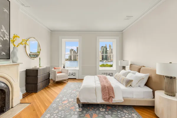 a spacious bedroom with a bed couch and a window