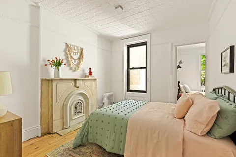 a bedroom with a bed and a window