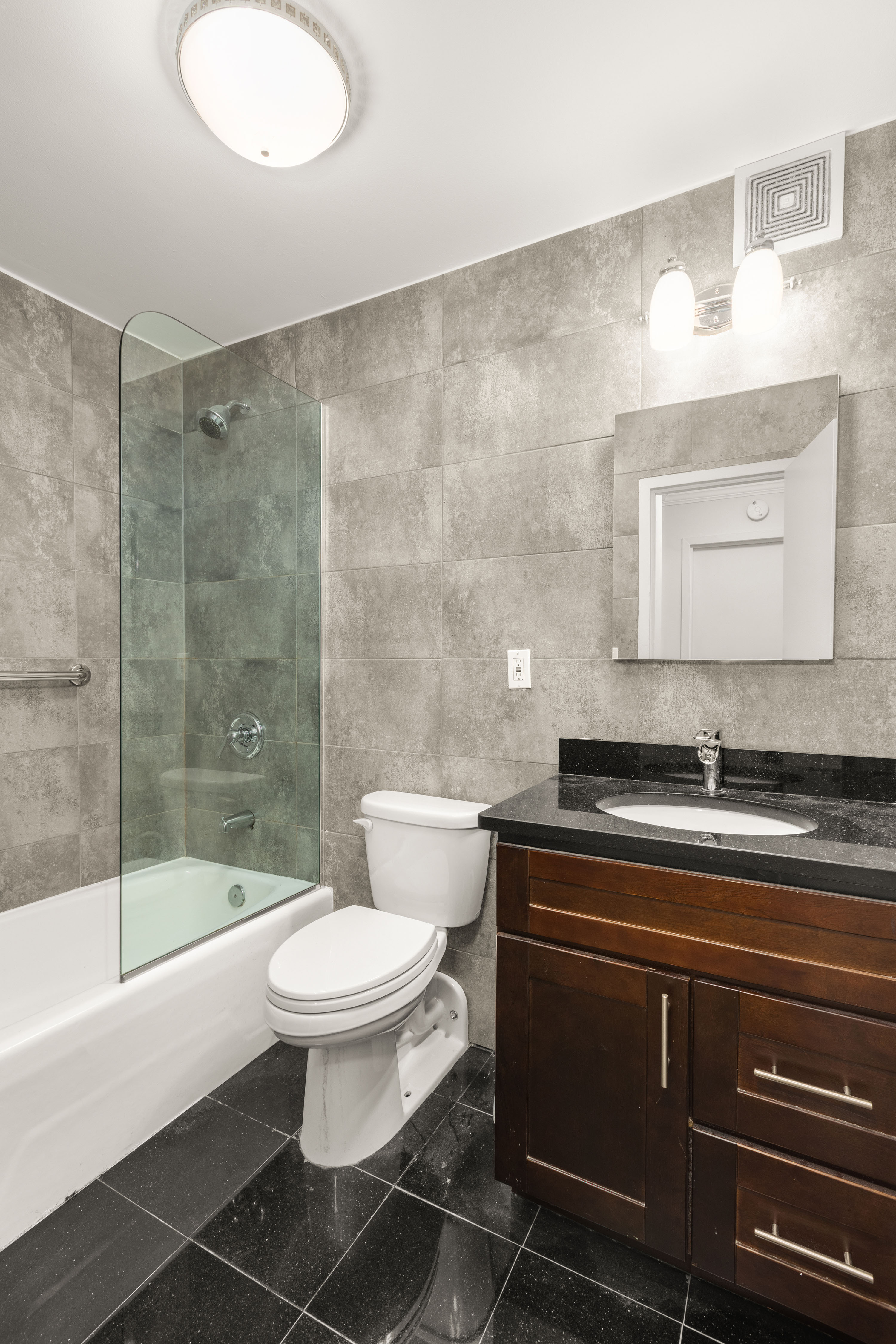 7 East 35th Street, Unit 2E Manhattan, NY 10016 - Photo 5 of 10 a bathroom with a sink a toilet and shower