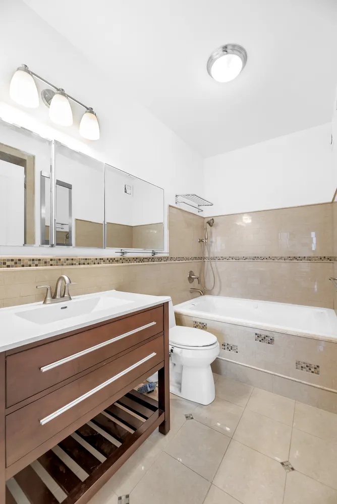 a bathroom with a sink a toilet and a mirror