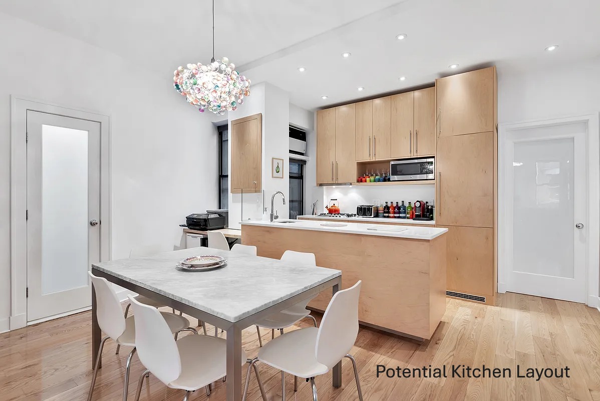 615 West 113th Street, Unit 3132 Manhattan, NY 10025 - Photo 4 of 13 a kitchen with a table and chairs in it