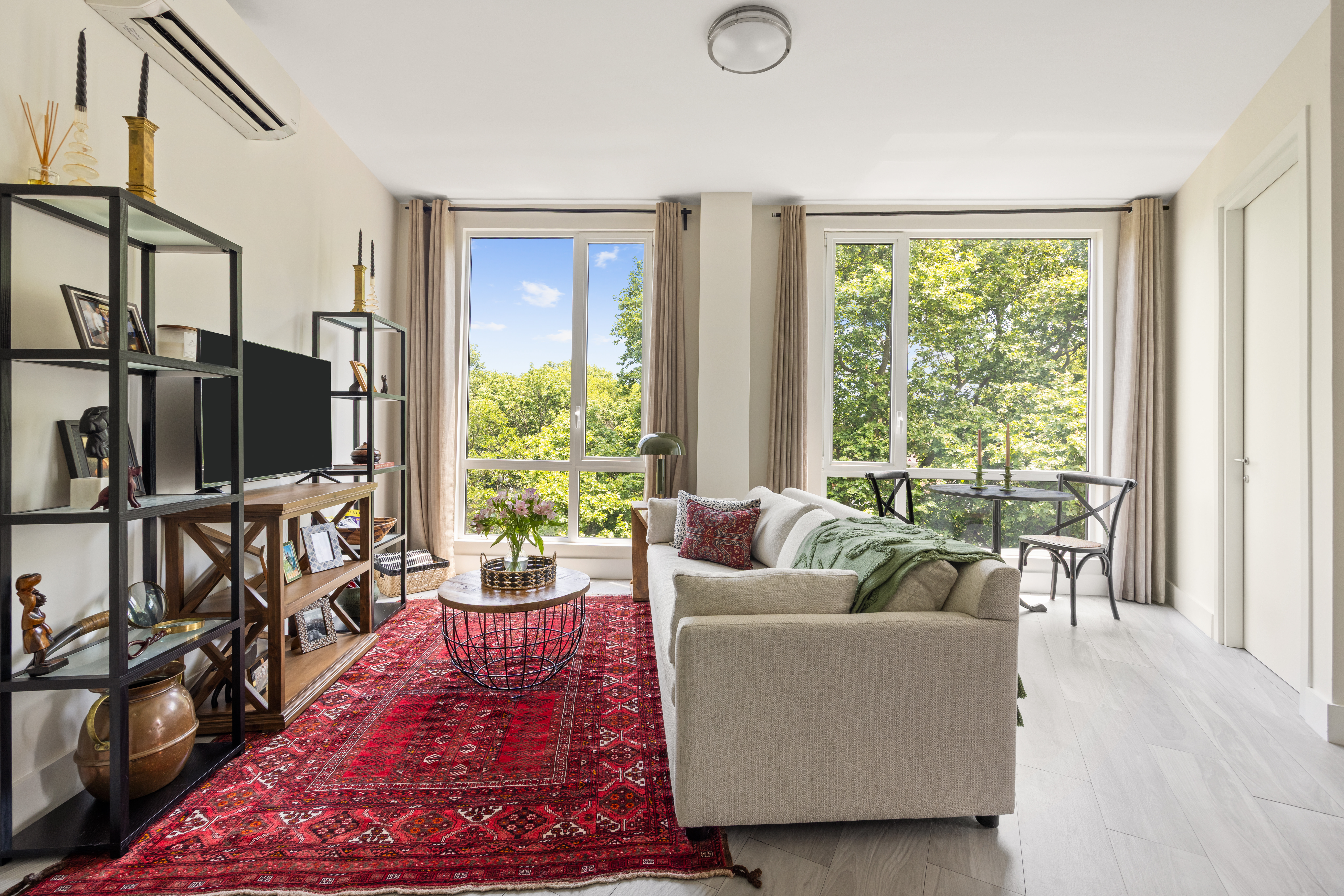 a living room with furniture tv and a window