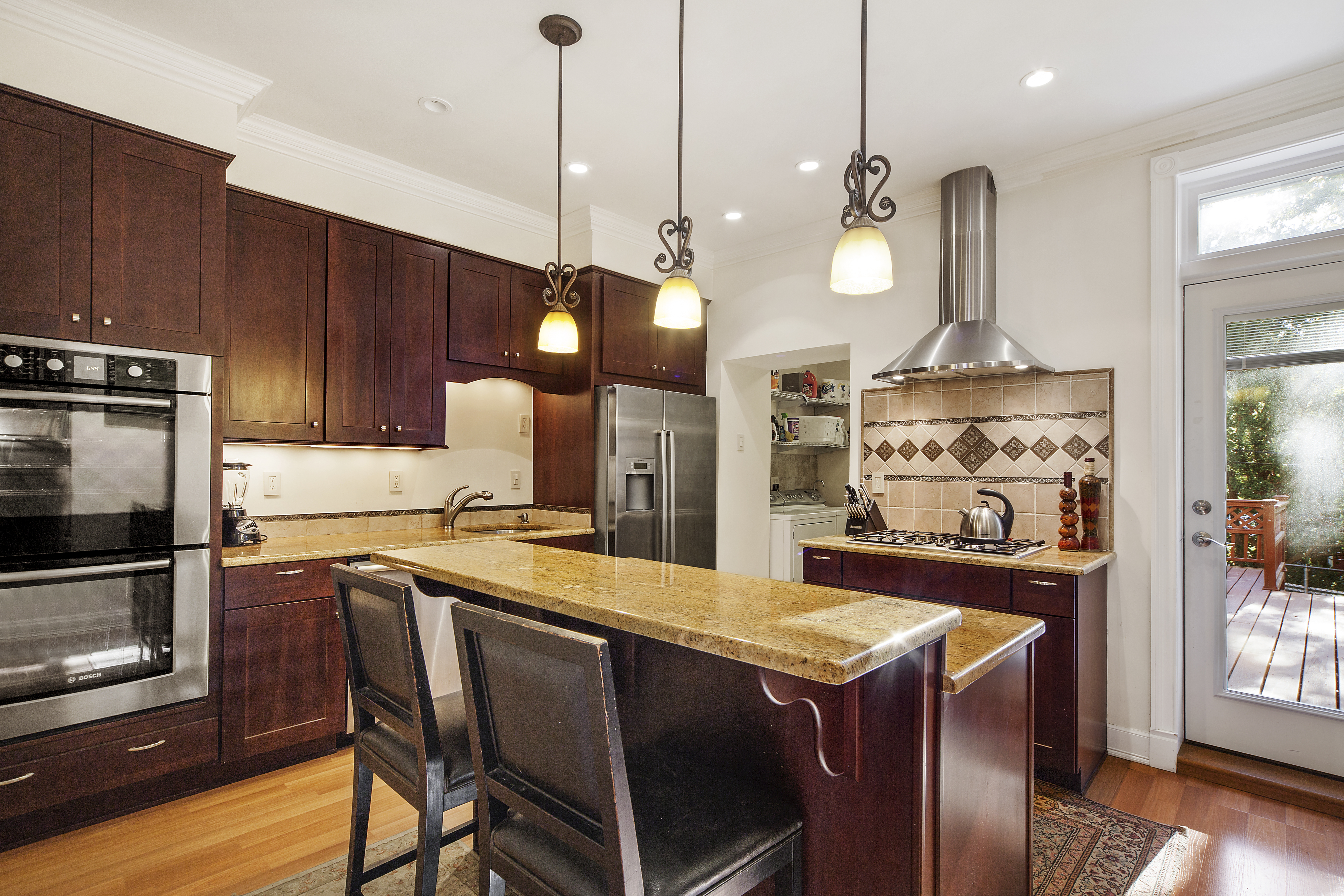 656 Union Street, Unit 2 Brooklyn, NY 11215 - Photo 5 of 12 a kitchen with a stove a refrigerator a sink a dining table and chairs with wooden floor
