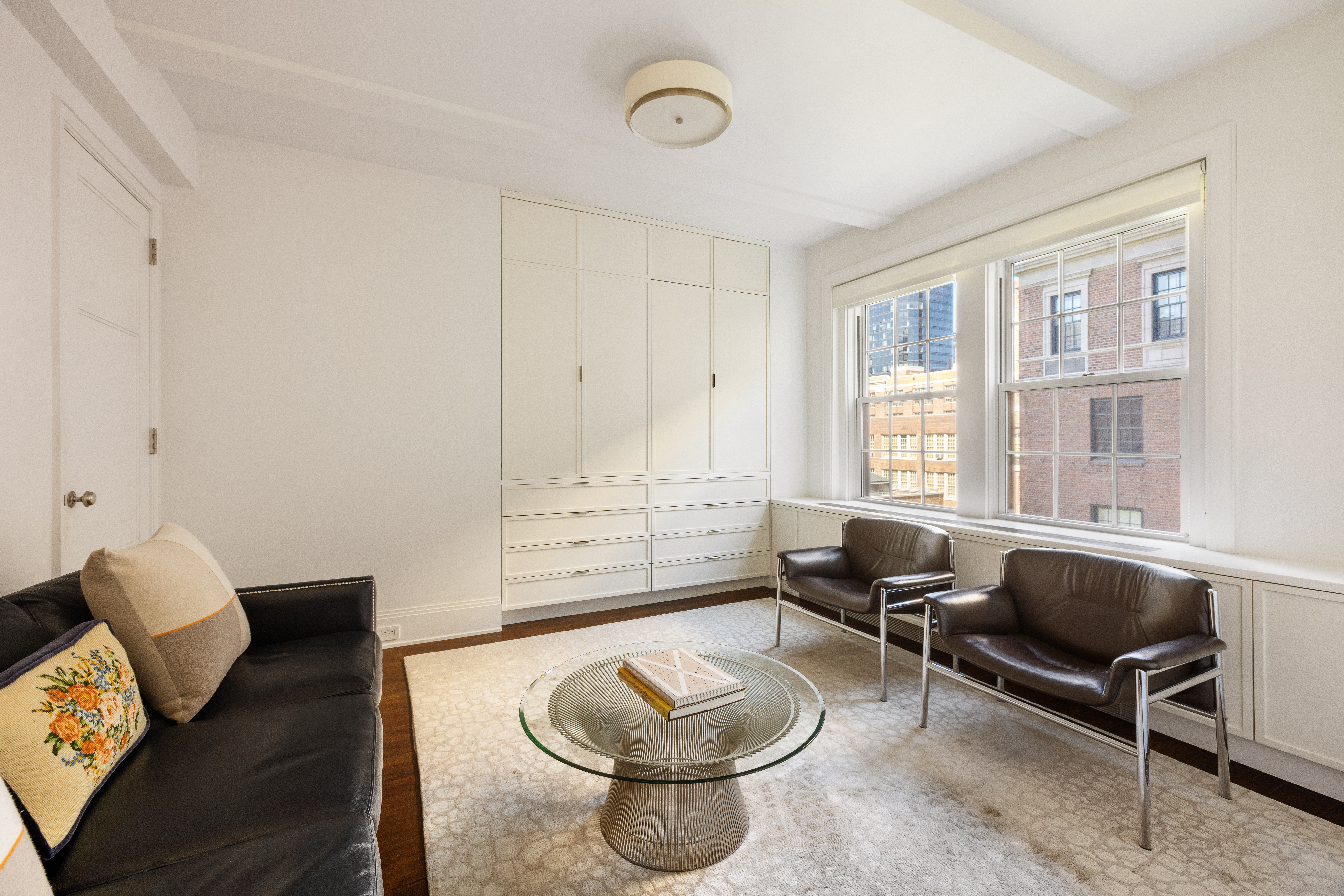 333 East 68th Street, Unit 8A Manhattan, NY 10065 - Photo 8 of 16 a living room with furniture and a window