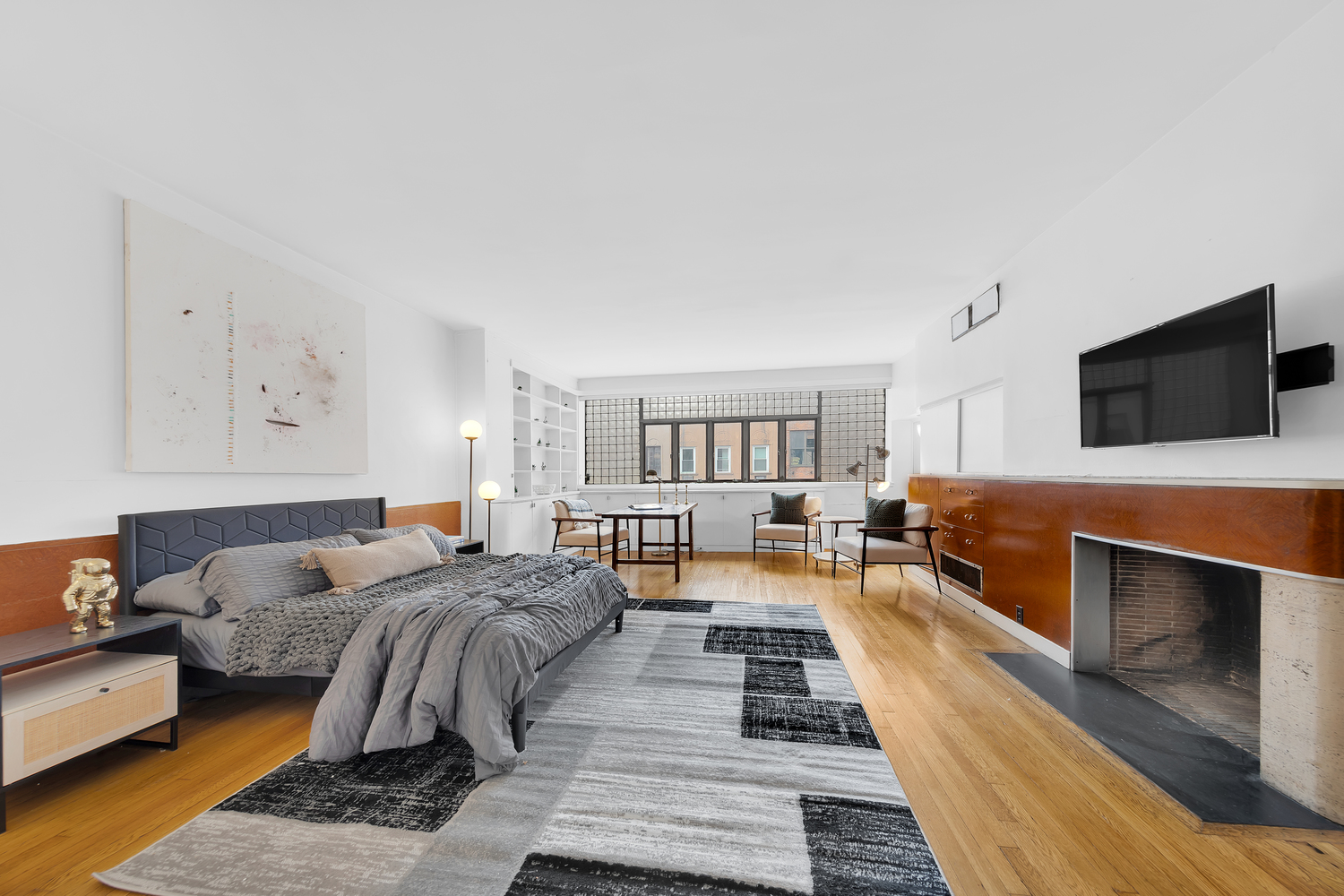 219 East 49th Street Manhattan, NY 10017 - Photo 6 of 19 a living room with furniture and a flat screen tv