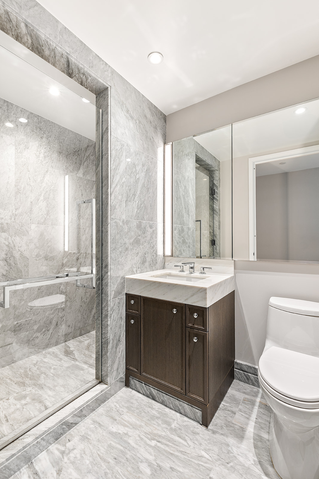 10 Riverside Boulevard, Unit 30B Manhattan, NY 10069 - Photo 6 of 19 a bathroom with a sink vanity mirror and toilet