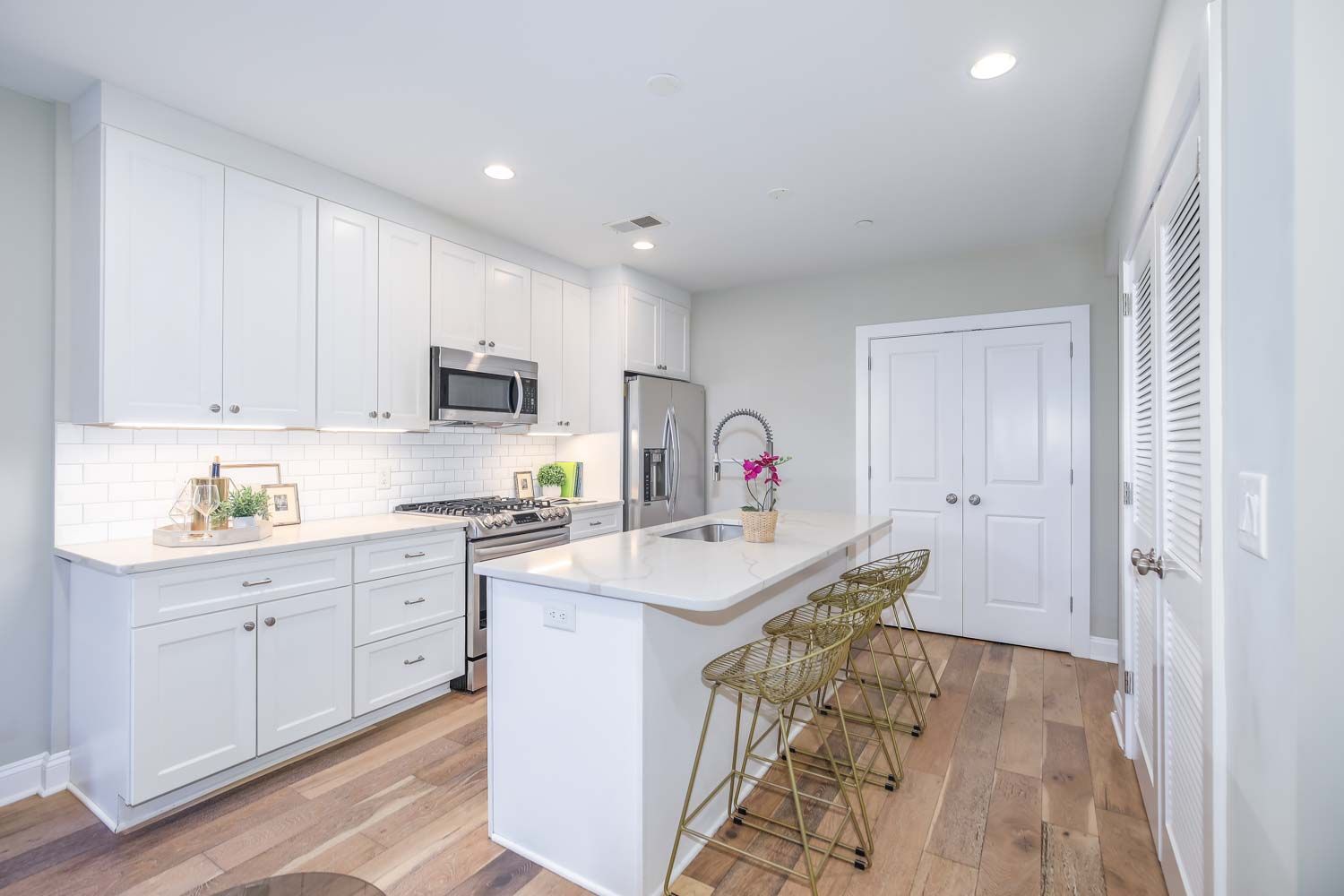 a kitchen with granite countertop a sink stove and cabinets