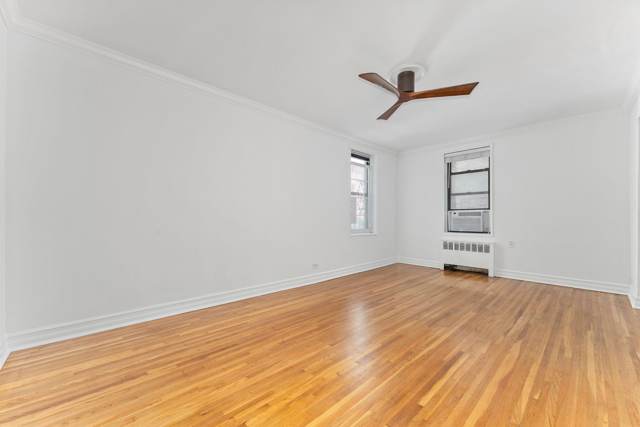 675 Academy Street, Unit 3A Manhattan, NY 10034 - Photo 4 of 12 wooden floor in an empty room