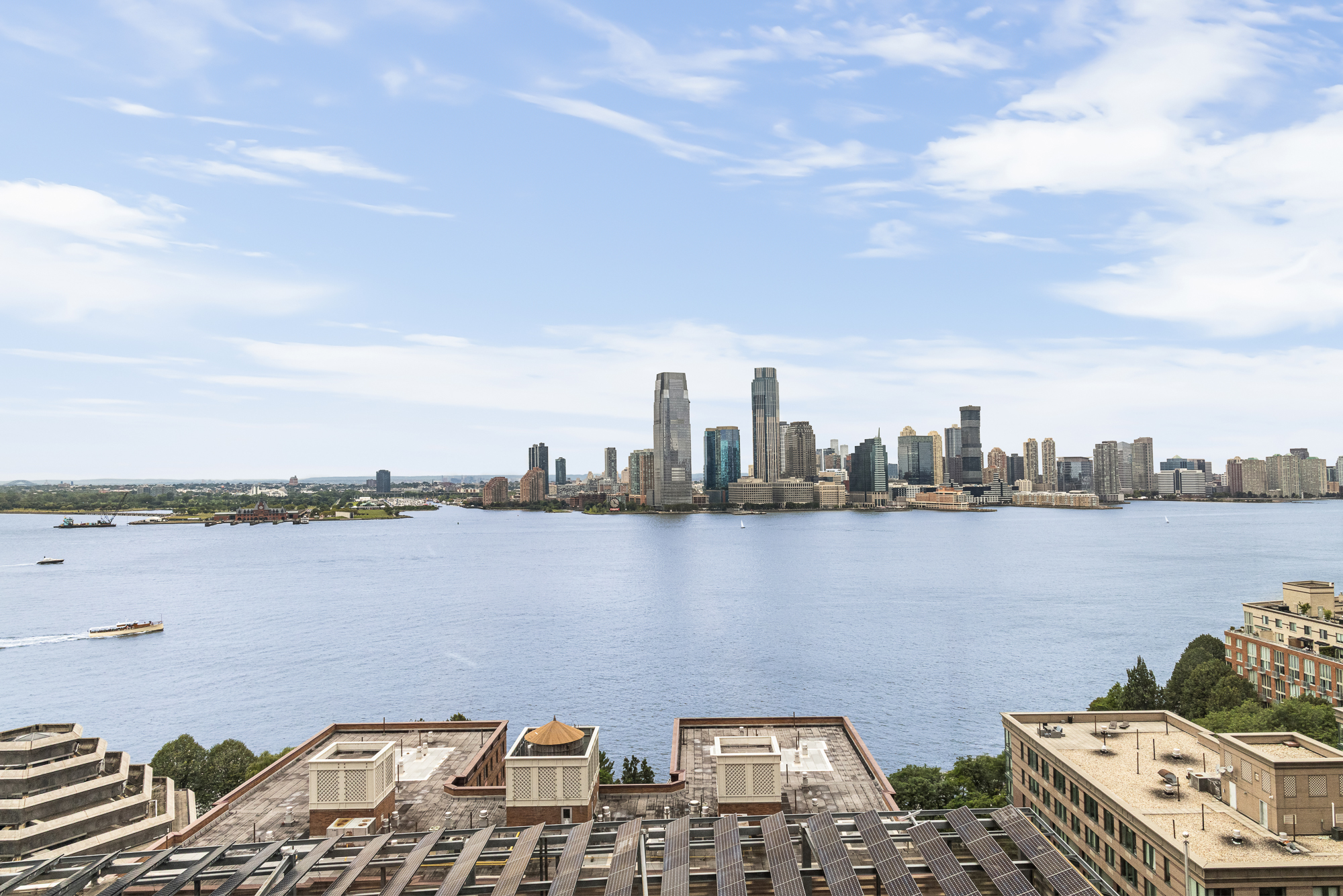 30 West Street, Unit 19A Manhattan, NY 10004 - Photo 10 of 12 a view of a city and ocean