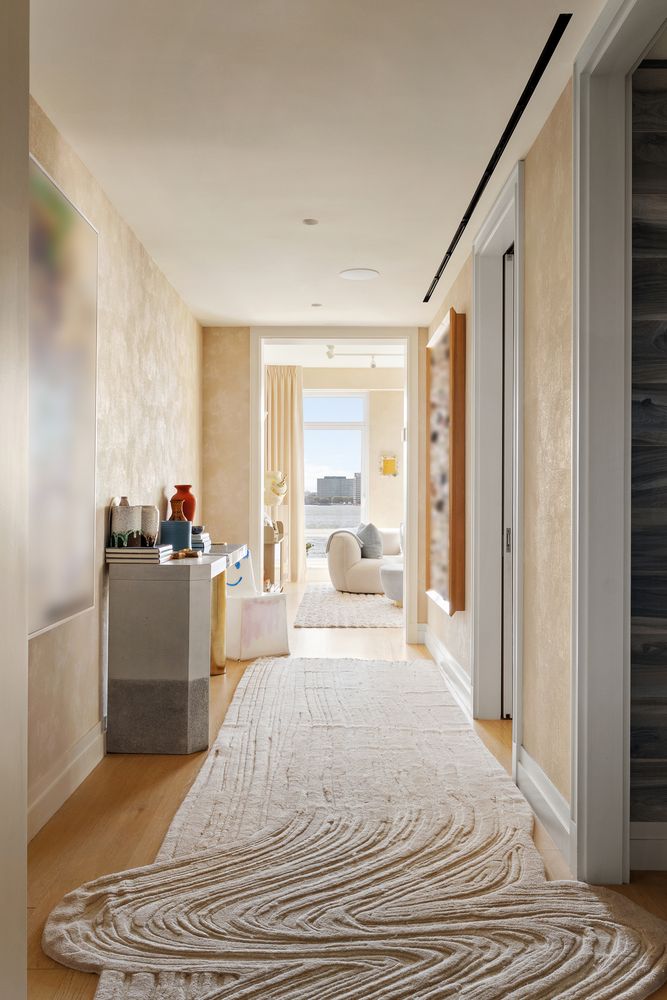 a bedroom with a bed and a large mirror with window