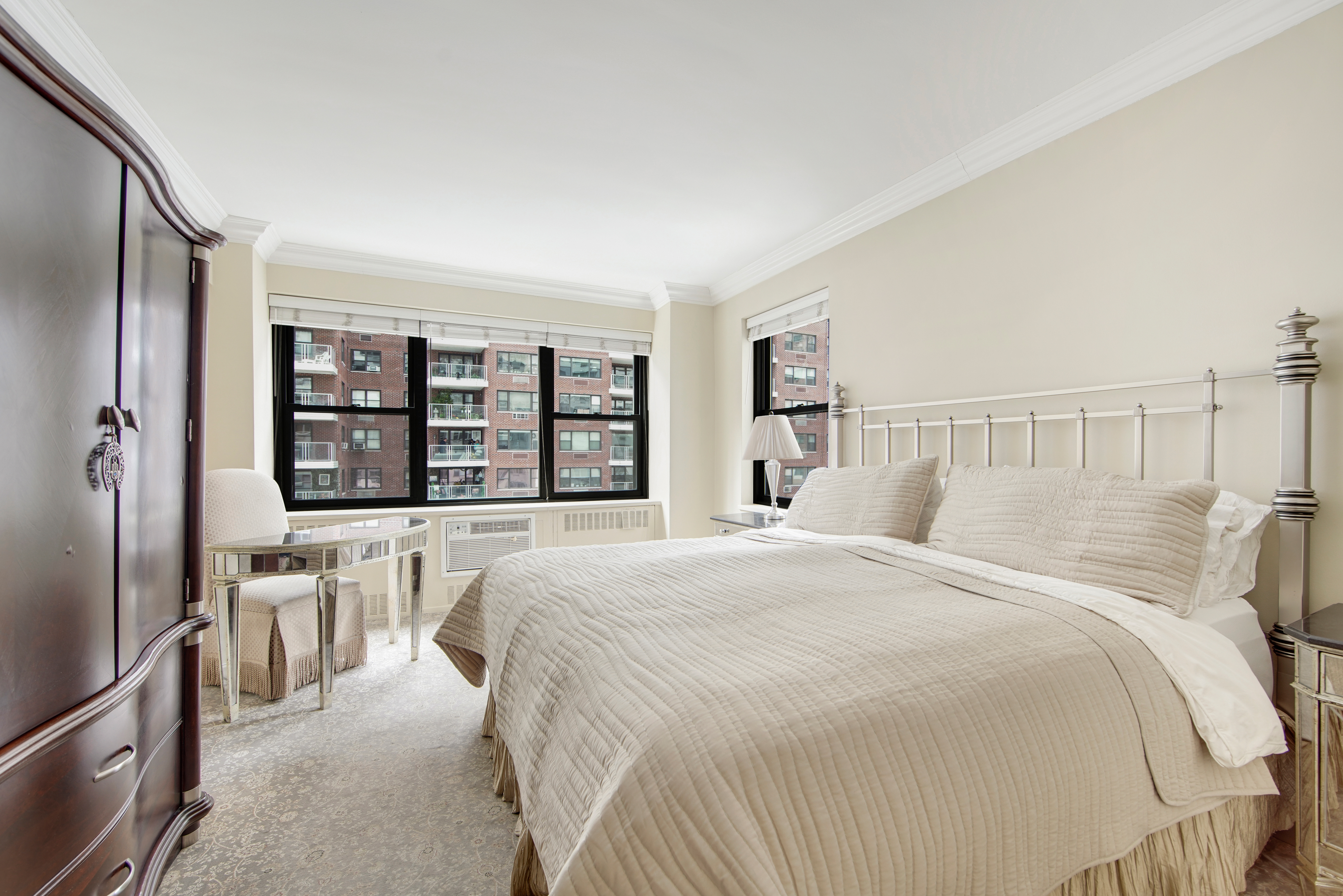 45 Sutton Place South, Unit 9O Manhattan, NY 10022 - Photo 8 of 16 a bedroom with a large bed and a window