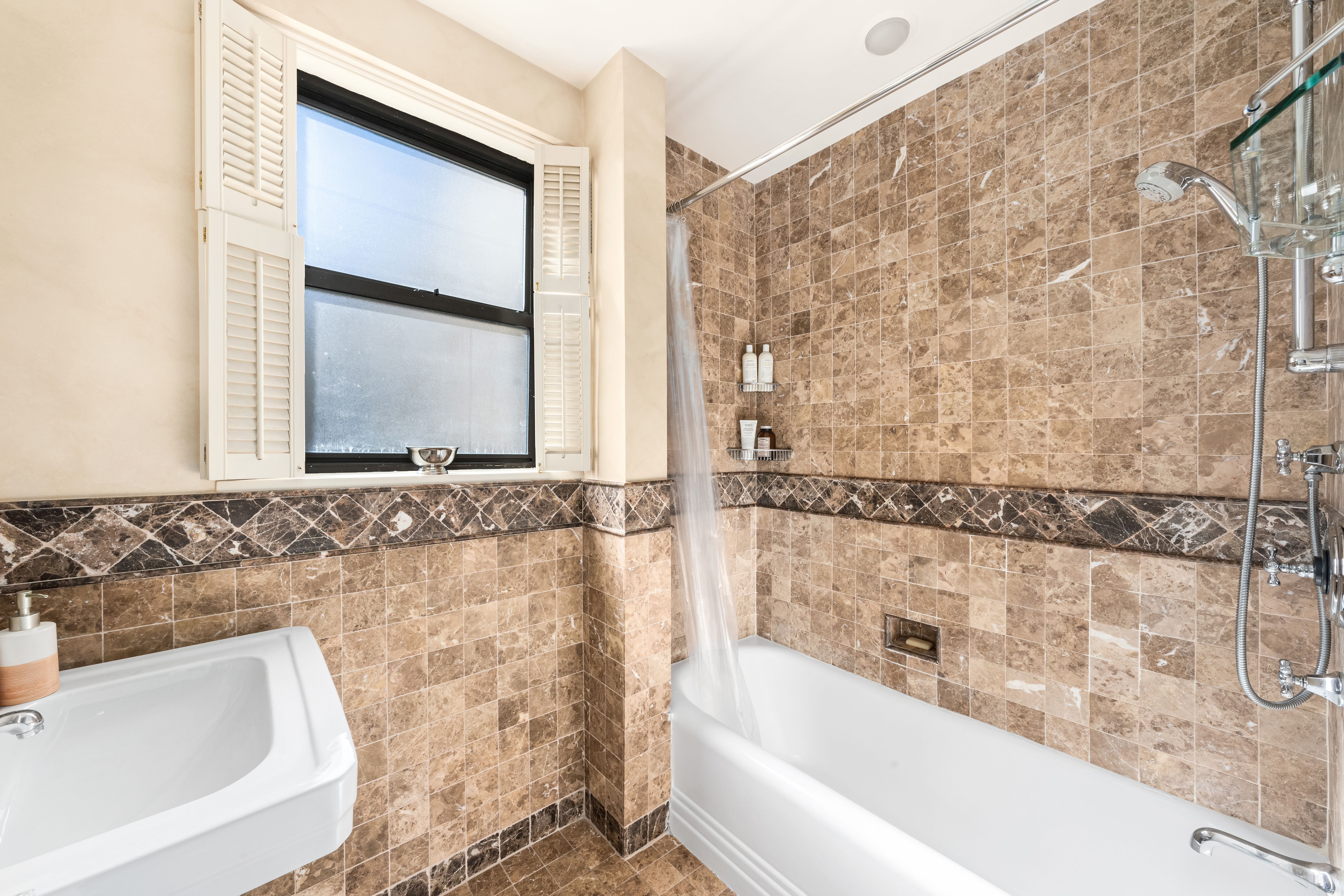 41 West 82nd Street, Unit 9D Manhattan, NY 10024 - Photo 10 of 15 a bathroom with a bathtub and a sink