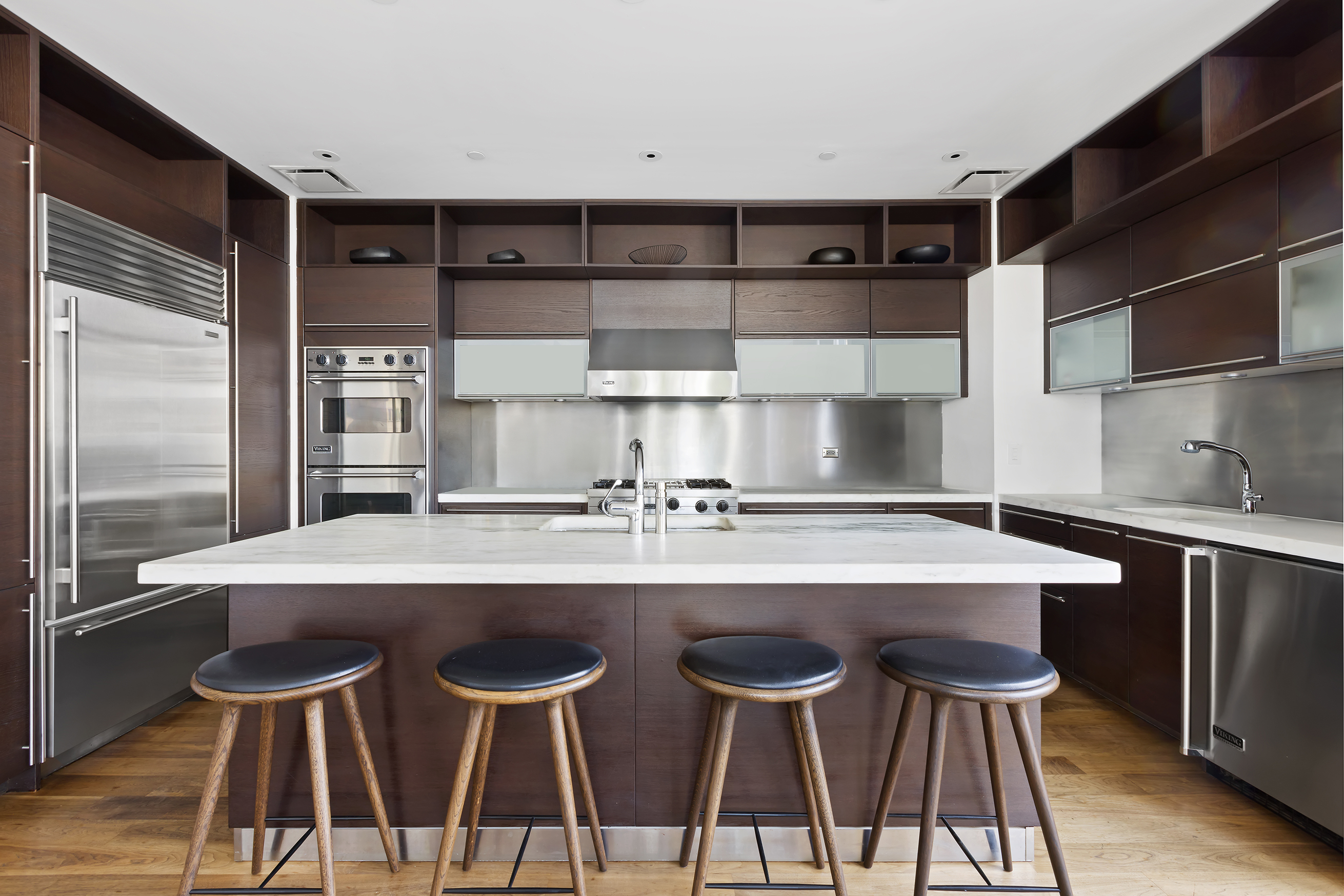 34 Leonard Street, Unit PH Manhattan, NY 10013 - Photo 5 of 30 a kitchen with a sink and chairs