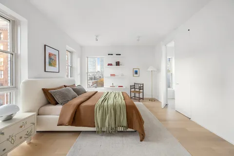 a bedroom with a bed and window
