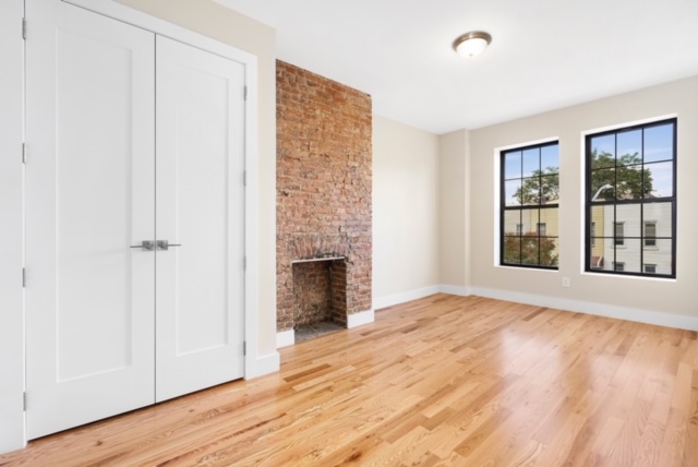 14 Pilling Street Brooklyn, NY 11207 - Photo 9 of 14 a view of an empty room with a window and wooden floor