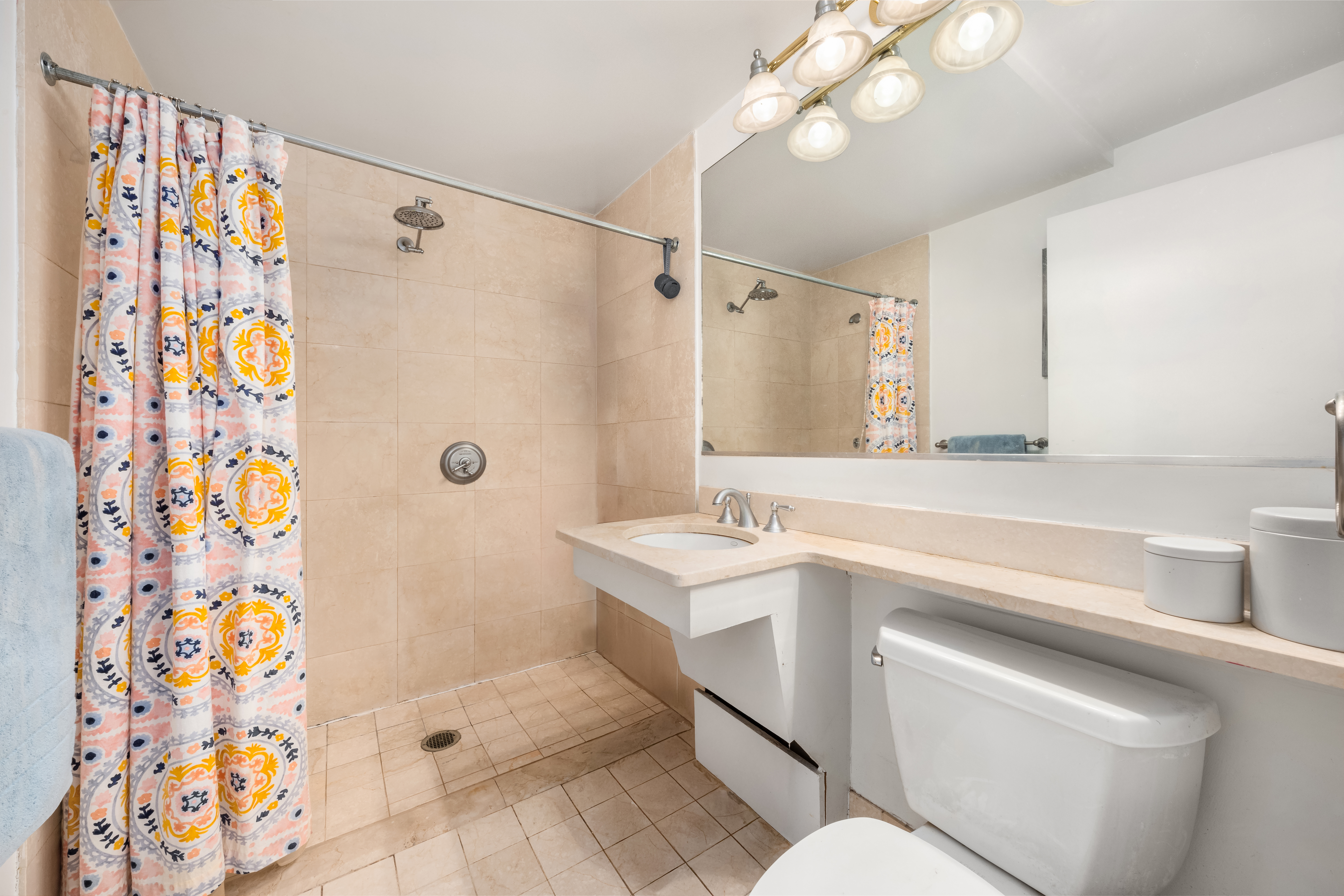 1760 2nd Avenue, Unit 5E Manhattan, NY 10128 - Photo 5 of 6 a bathroom with a sink a toilet and shower