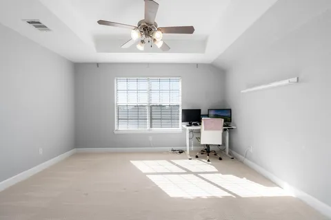 a room with a window furniture and chandelier