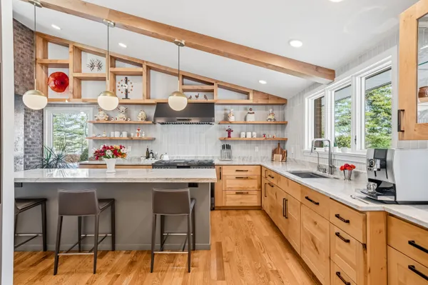 a kitchen with stainless steel appliances granite countertop a sink and cabinets
