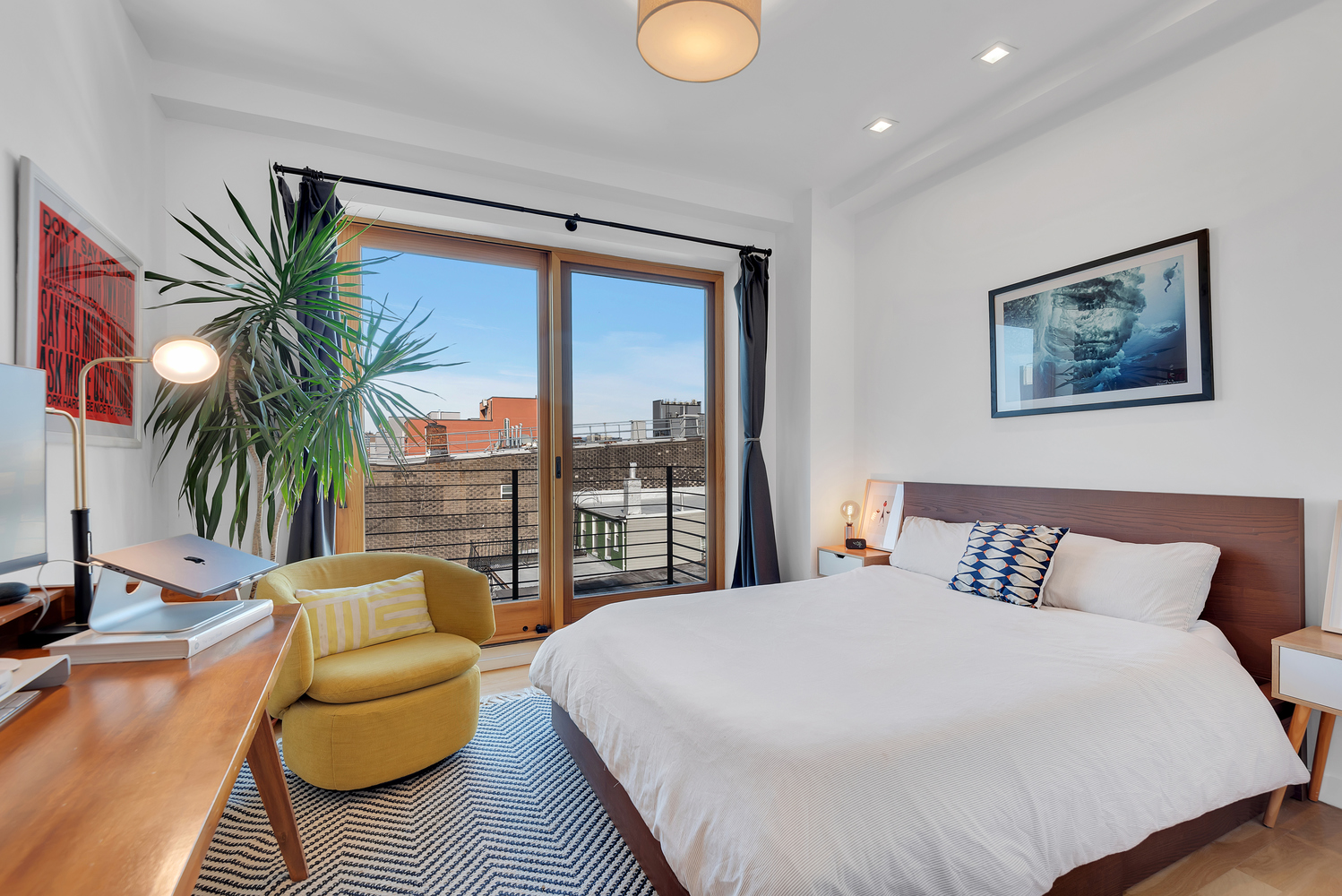 267 Evergreen Avenue, Unit PH Brooklyn, NY 11221 - Photo 12 of 19 a bedroom with furniture and a large window