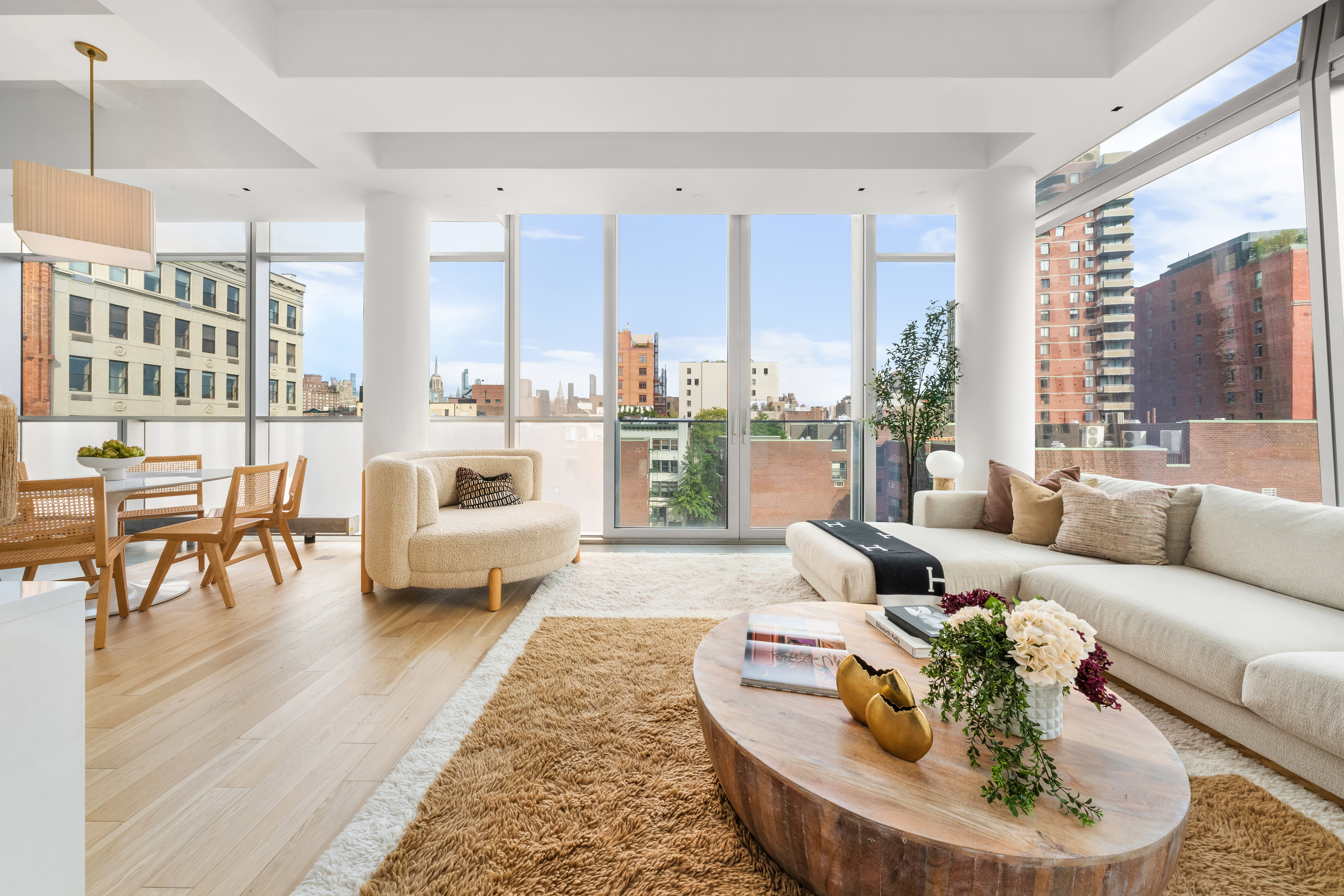 166 Perry Street, Unit 6B Manhattan, NY 10014 - Photo 1 of 14 a living room with furniture and a large window