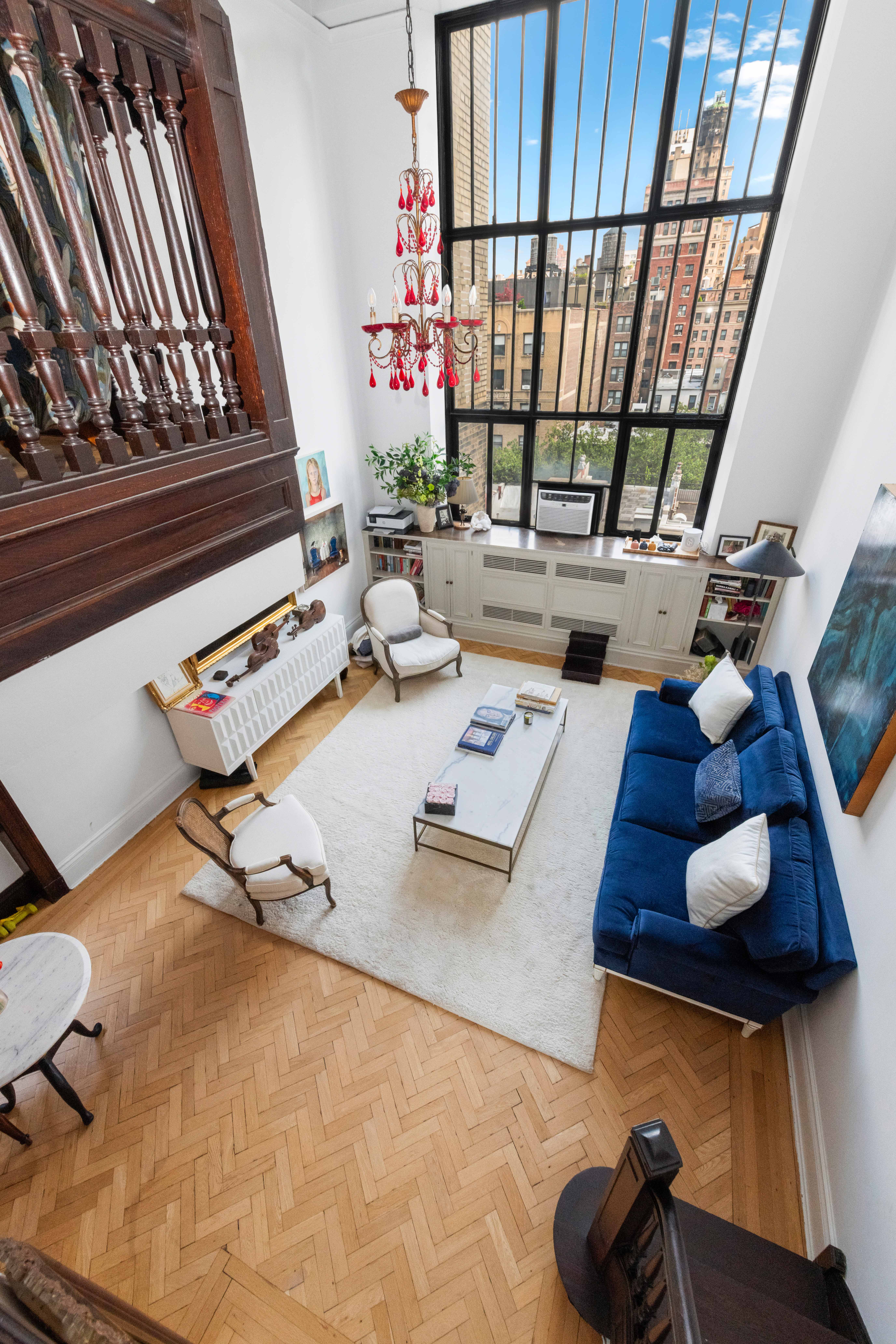 1 West 67th Street, Unit 608 Manhattan, NY 10023 - Photo 4 of 16 a living room with furniture and wooden floor