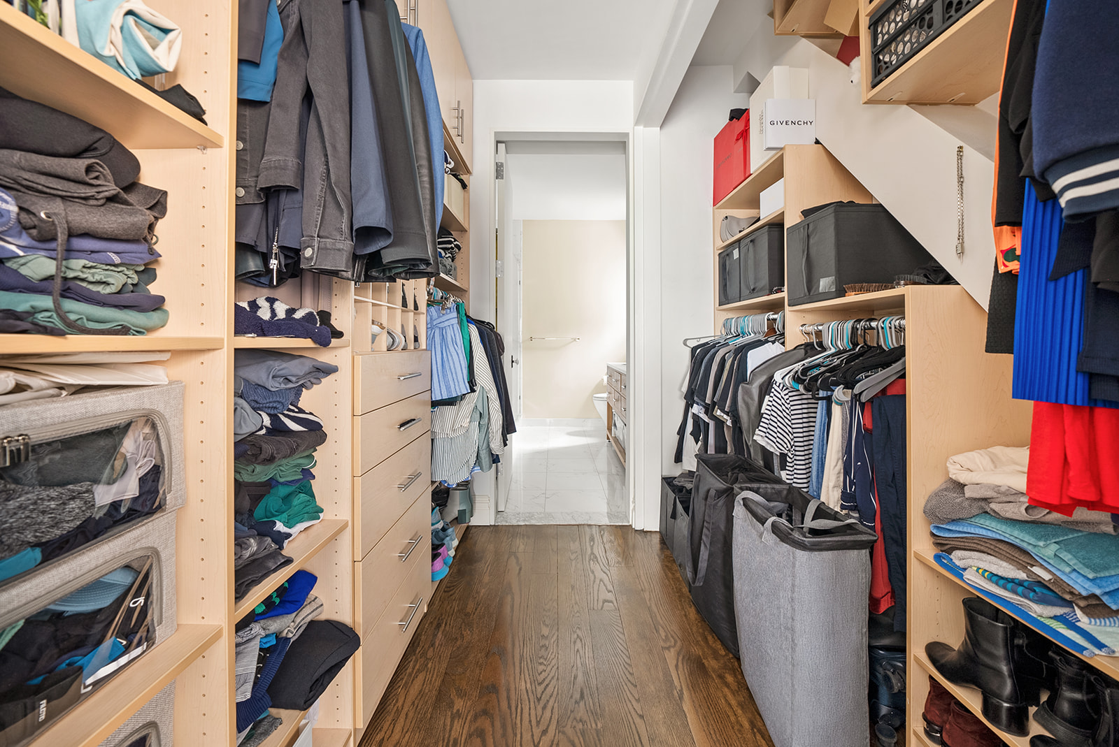 119 Fulton Street, Unit 8 Manhattan, NY 10038 - Photo 6 of 12 a view of walk in closet with clothes and shoes