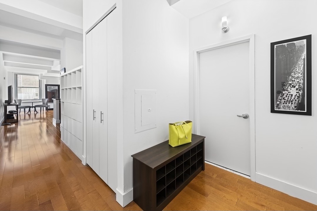 80 John Street, Unit 11E Manhattan, NY 10038 - Photo 3 of 9 a room with furniture and wooden floor