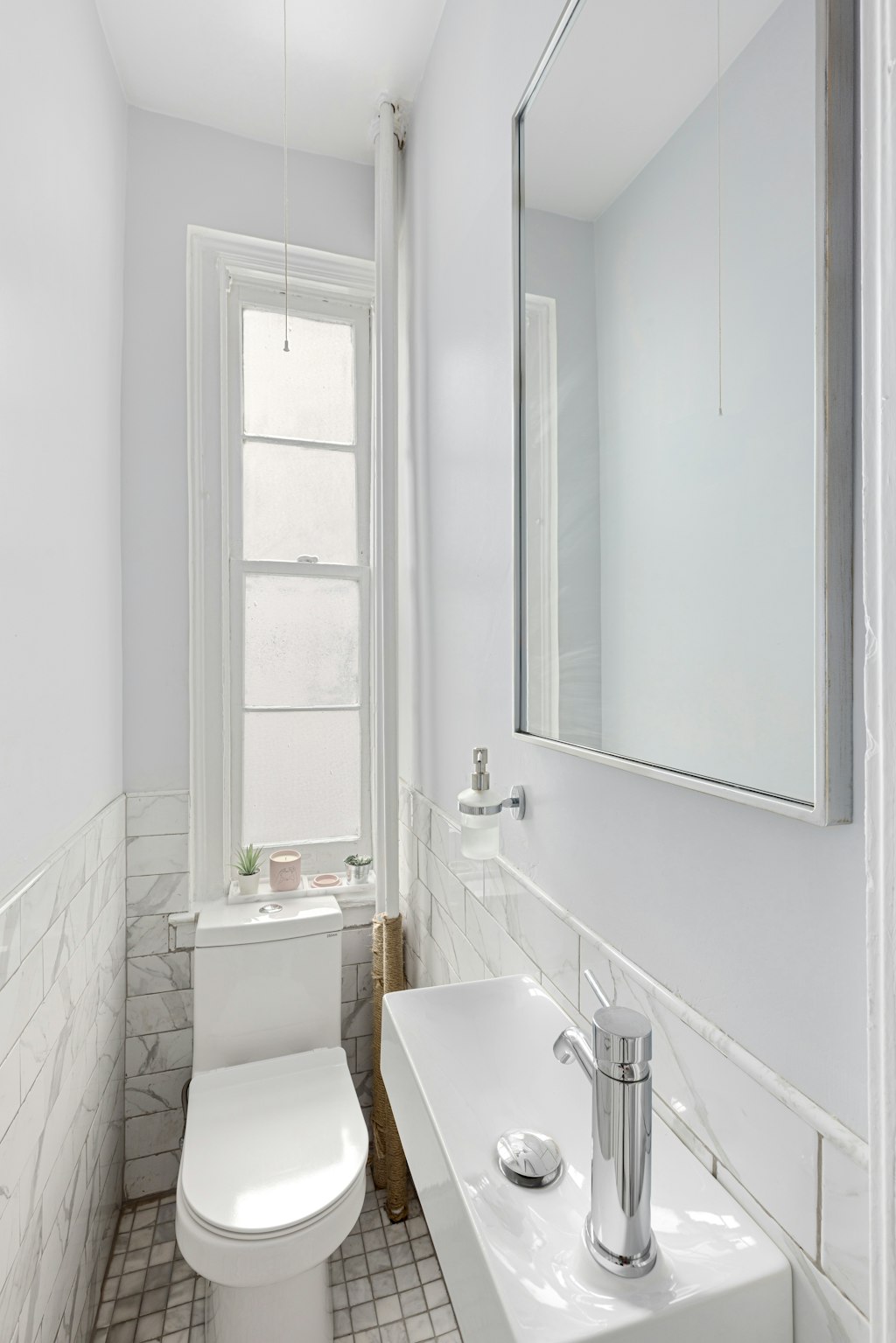 522 West End Avenue, Unit 2B Manhattan, NY 10024 - Photo 7 of 8 a white toilet sitting next to a bathroom sink