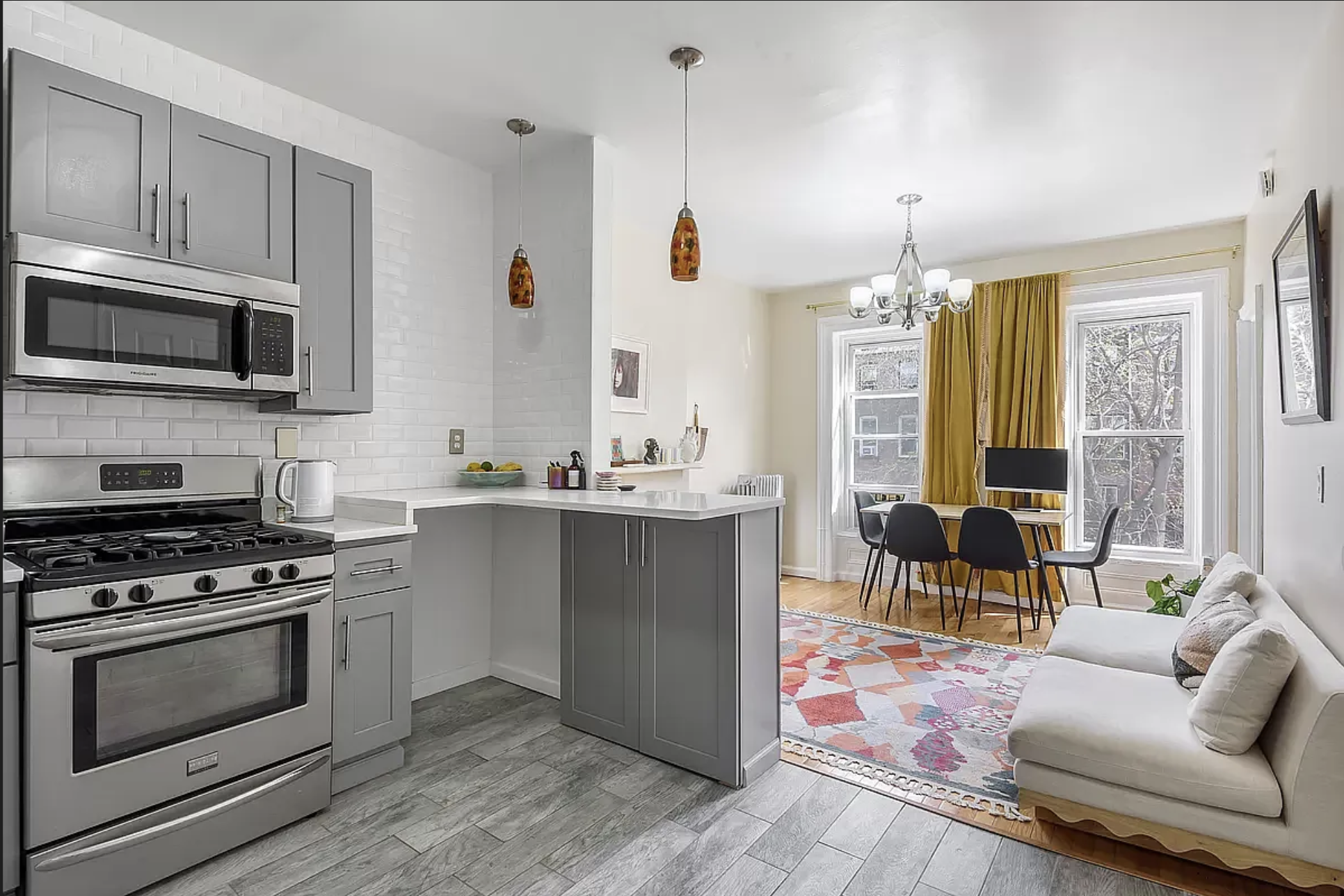 582 Monroe Street, Unit 2 Brooklyn, NY 11221 - Photo 4 of 18 a kitchen with stainless steel appliances kitchen island granite countertop a stove a sink and a microwave