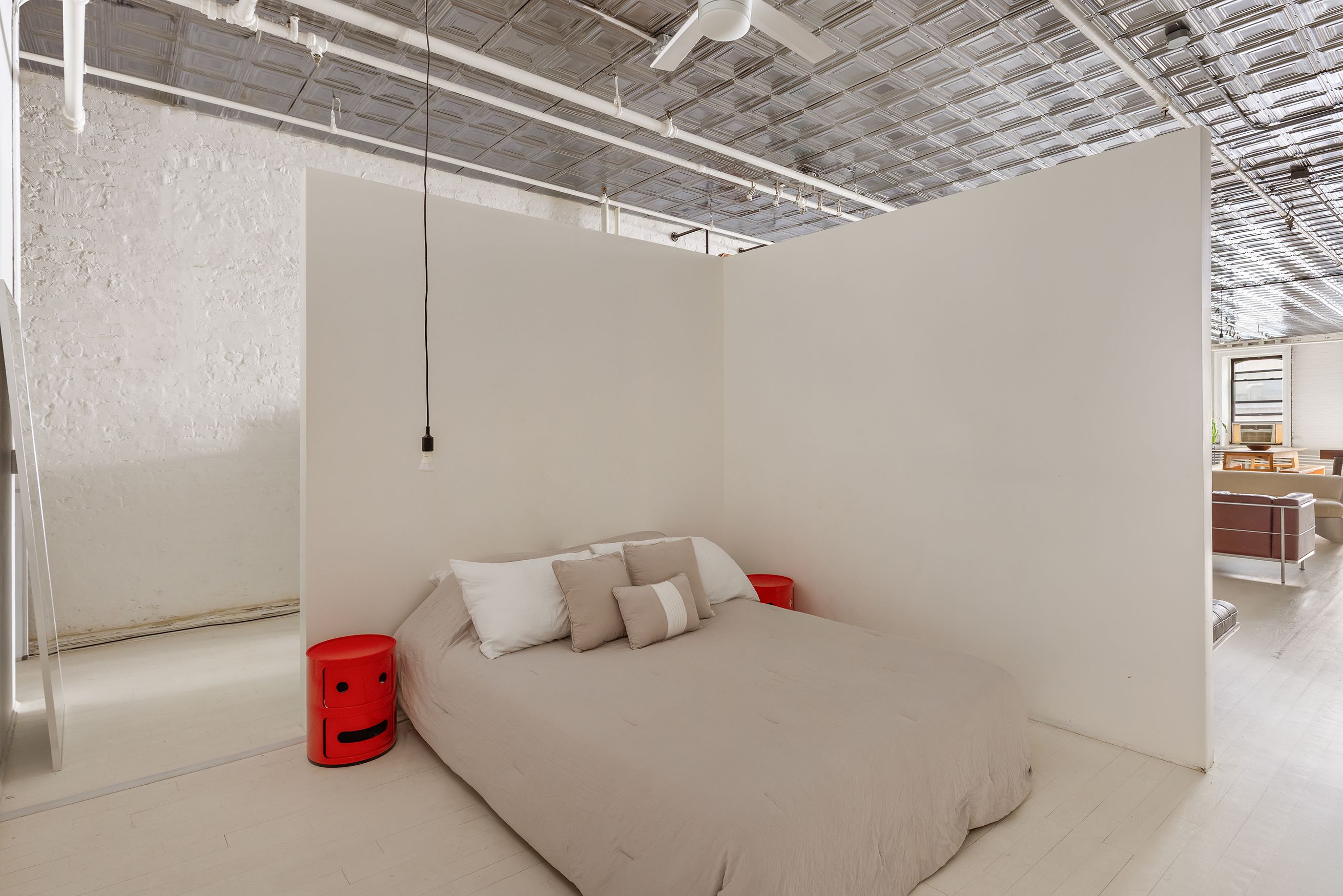 49 Howard Street, Unit 4S Manhattan, NY 10013 - Photo 7 of 12 a bedroom with a bed and a table with potted plants