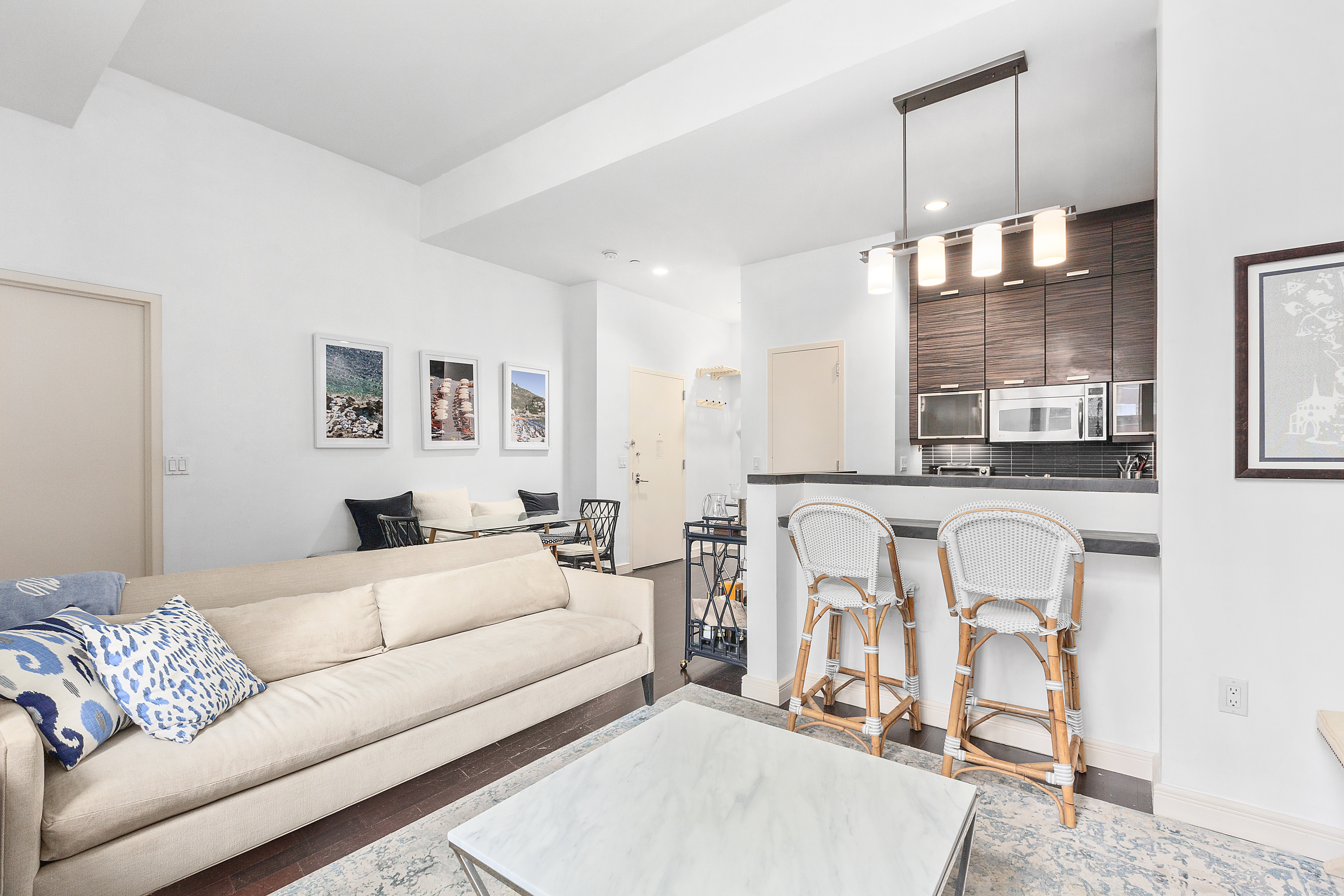 101 West 24th Street, Unit 4G Manhattan, NY 10011 - Photo 4 of 7 a living room with furniture gym equipment and a rug