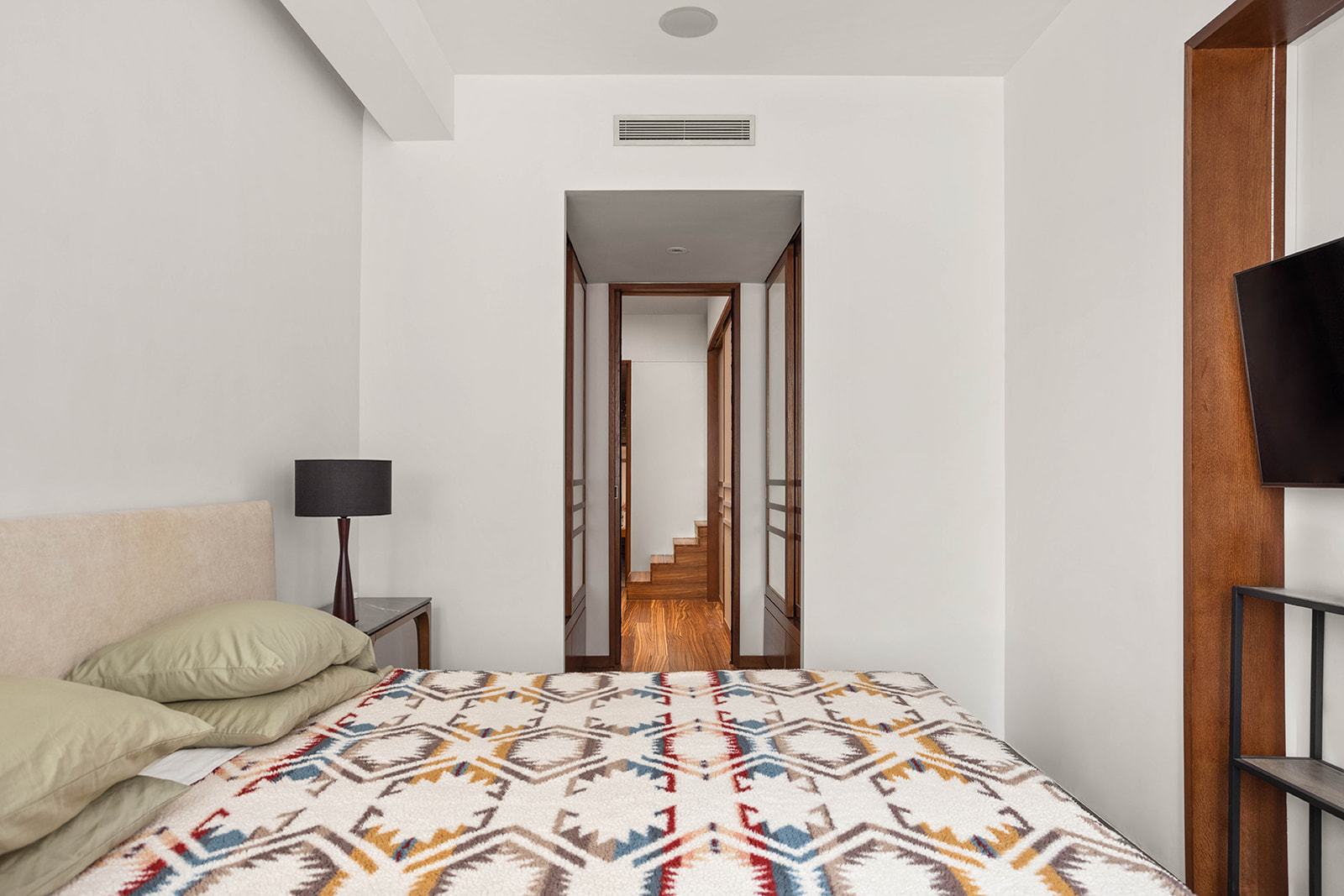 244 West 23rd Street, Unit 3A Manhattan, NY 10011 - Photo 5 of 11 a bedroom with a bed and a flat screen tv