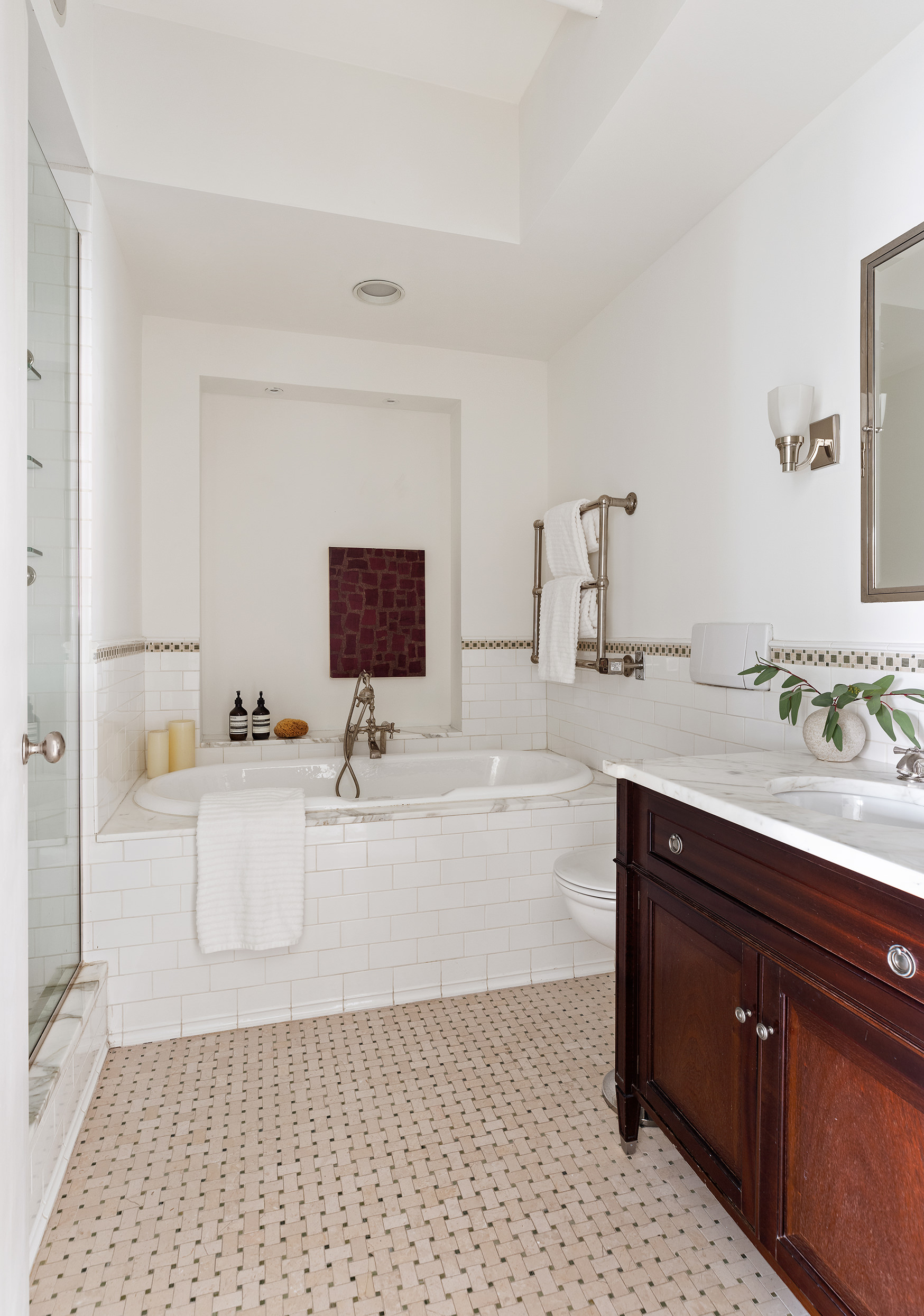 169 Mercer Street, Unit PH Manhattan, NY 10012 - Photo 10 of 15 a bathroom with a tub sink and mirror