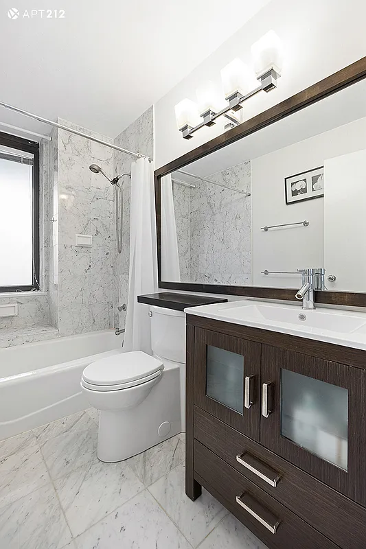 311 East 38th Street, Unit 12B Manhattan, NY 10016 - Photo 7 of 10 a bathroom with a sink mirror vanity and toilet