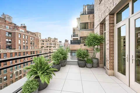 a view of a building with potted plants